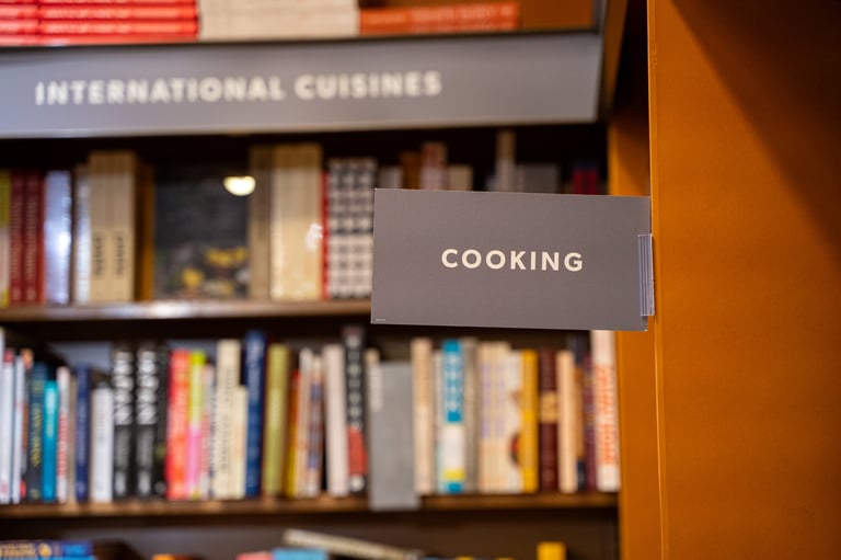Published cookbooks on the shelves of a bookstore cooking section